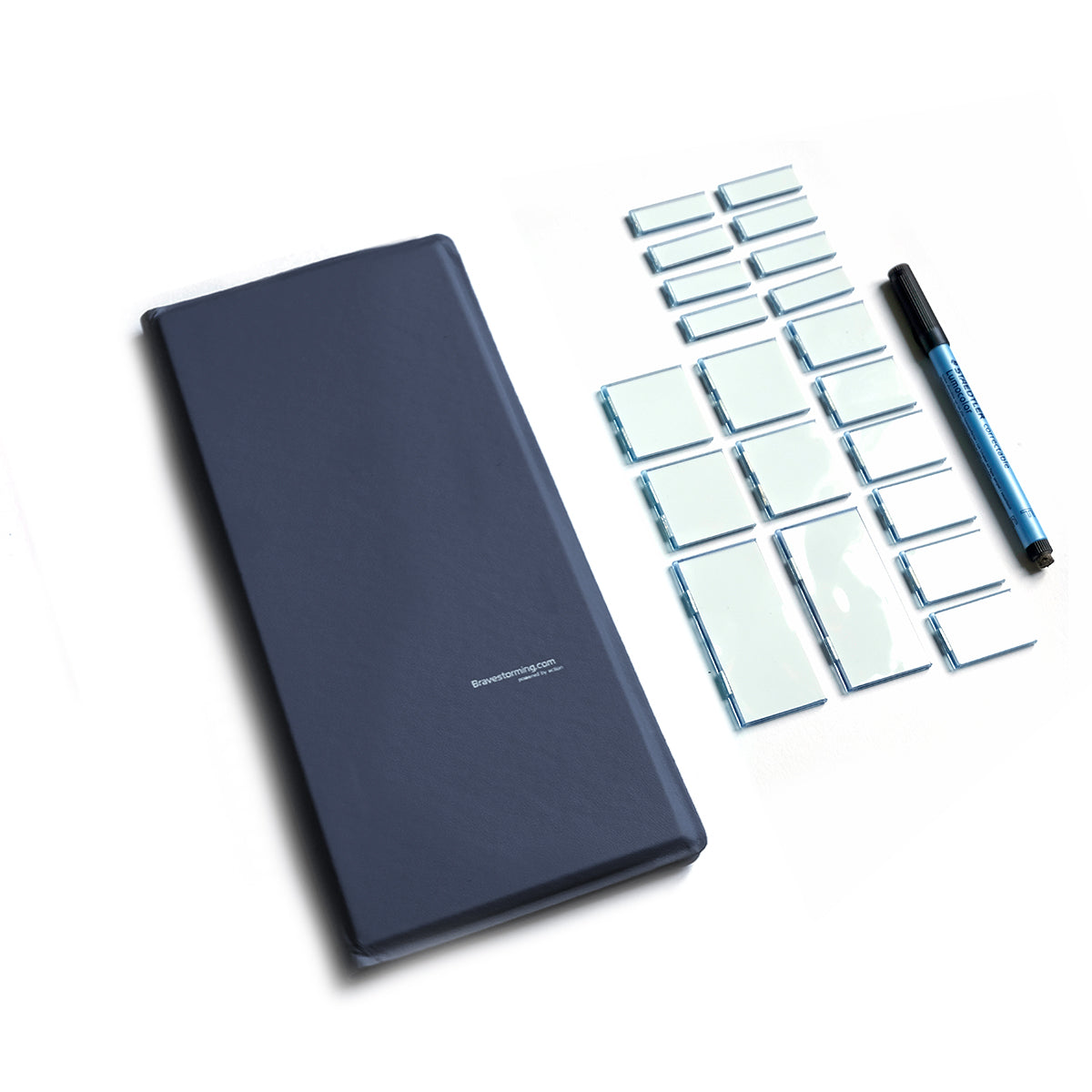 blue note pad, notebook, magnetic whiteboard with pen
