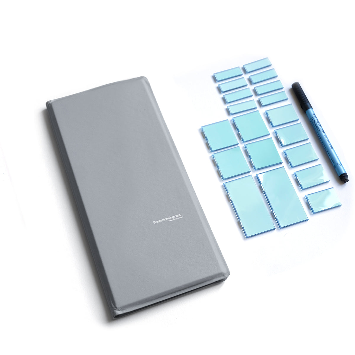 Gray notepad with blue keyboard stickers and a pen on a white background