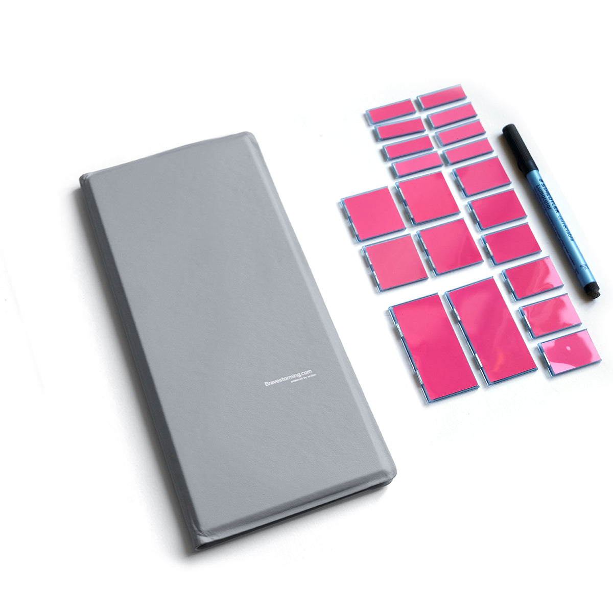 Gray notebook with pink sticky notes and a pen on a white background