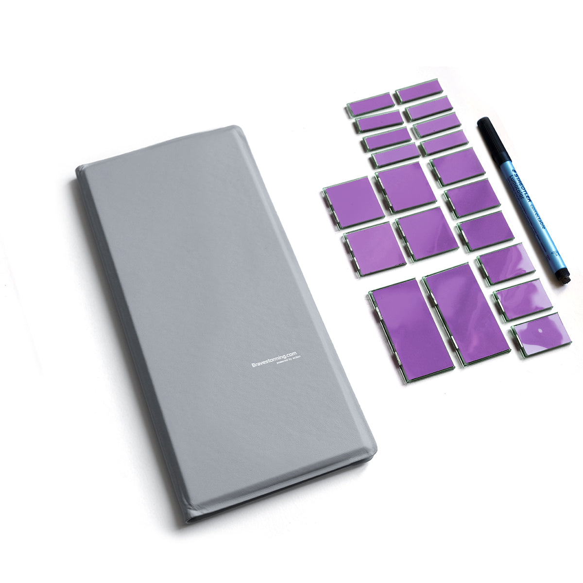 Gray notebook with purple stickers and a pen on a white background