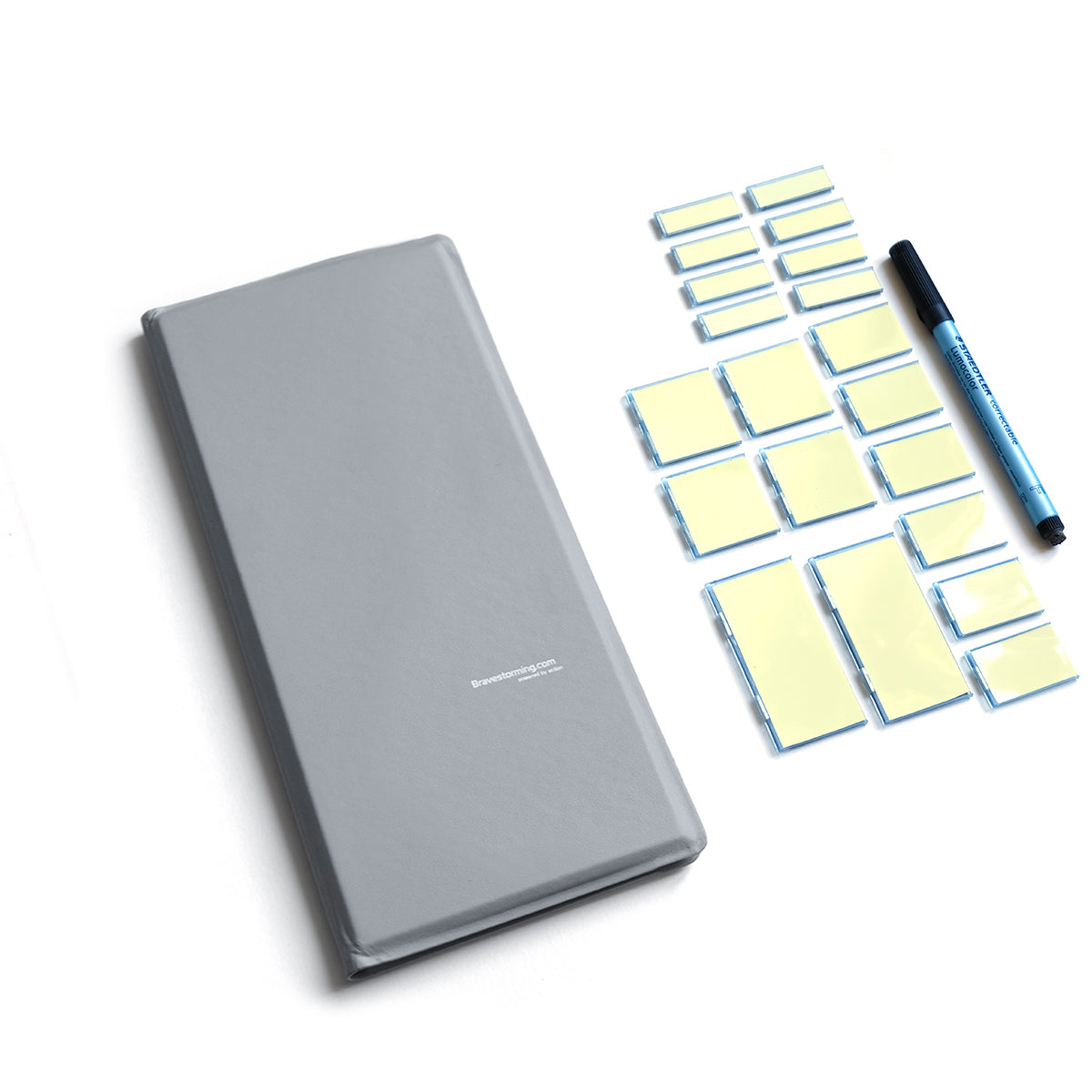 Gray notebook with yellow sticky notes and a blue pen on a white background