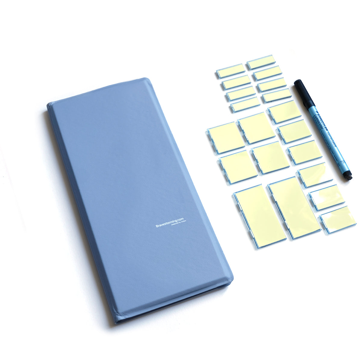 Blue notebook, yellow sticky notes, and a pen on a white background