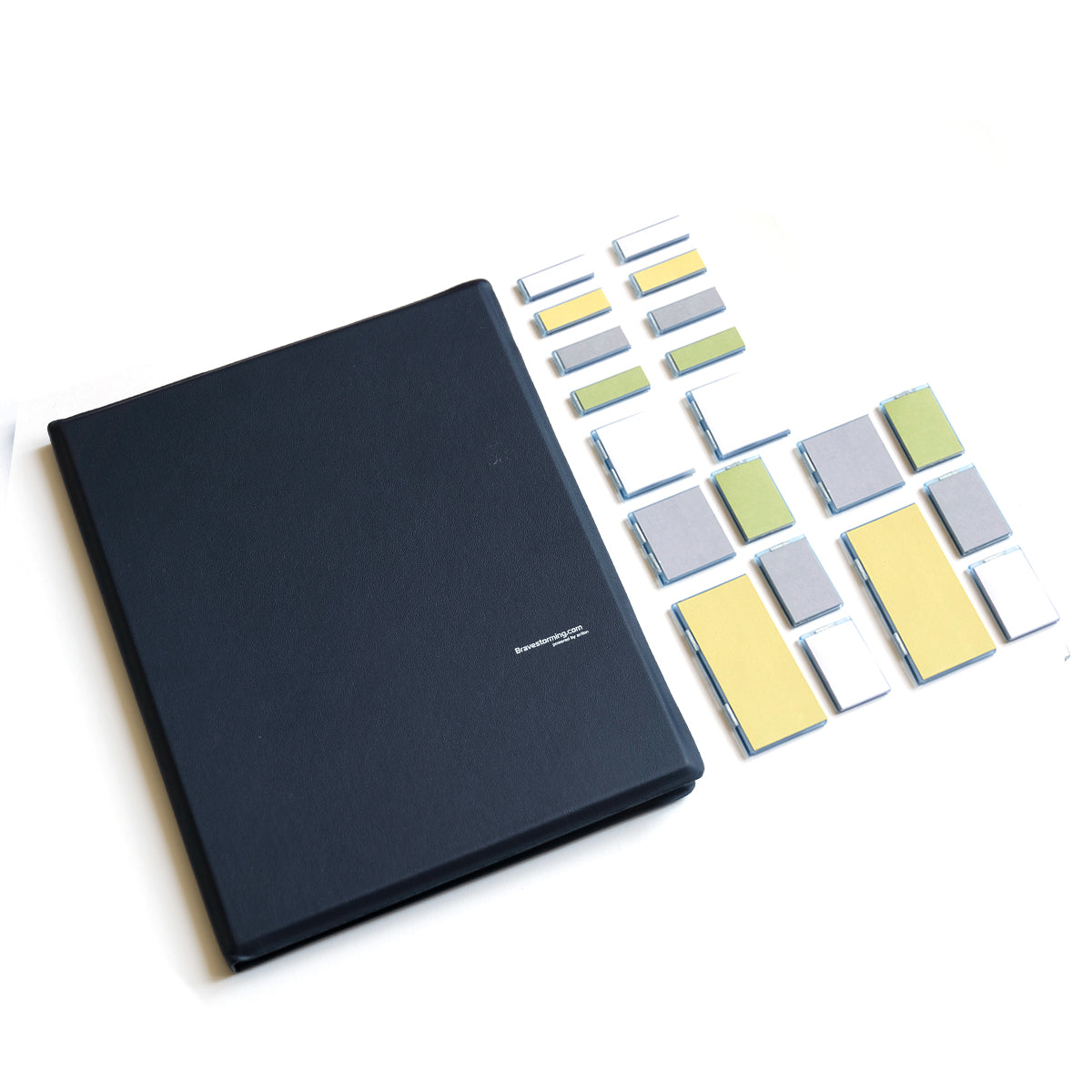 Black notebook with colorful square stickers on a white background